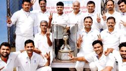 Players of Tata Motors pose with their trophy after defeating Soft Hard at the Tata Motors ground