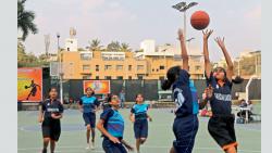 Players of Sardar Dastur High School (in orange) in action against Chonde Patil Basketball Academy