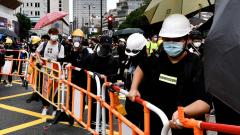 Protesters set up improvised barricades near The Peninsula hotel (back centre L) in the high-end shopping district of Tsim Sha Tsui in Hong Kong on Friday. Protesters set up improvised barricades near The Peninsula hotel (back centre L) in the high-end shopping district of Tsim Sha Tsui in Hong Kong on Friday.