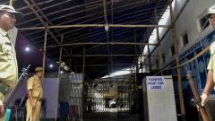 Police personnel stand guard near a strong room where EVMs are kept, on the eve of Lok Sabha elections results, at Balurghat in West Bengal on May 22, 2019. PTI Photo Police personnel stand guard near a strong room where EVMs are kept, on the eve of Lok Sabha elections results, at Balurghat in West Bengal on May 22, 2019. PTI Photo