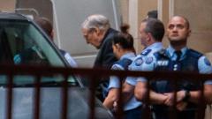 Jailed Australian Cardinal George Pell (C) is escorted to a white van as he leaves Victoria State's Supreme Court in Melbourne on June 5, 2019. AFP Photo Jailed Australian Cardinal George Pell (C) is escorted to a white van as he leaves Victoria State's Supreme Court in Melbourne on June 5, 2019. AFP Photo