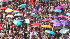 Women hold signs and umbrellas as they take part in a nation-wide women's strike for wage parity outside the federal palace, on June 14, 2019 in the Swiss capital Bern. AFP Photo Women hold signs and umbrellas as they take part in a nation-wide women's strike for wage parity outside the federal palace, on June 14, 2019 in the Swiss capital Bern. AFP Photo
